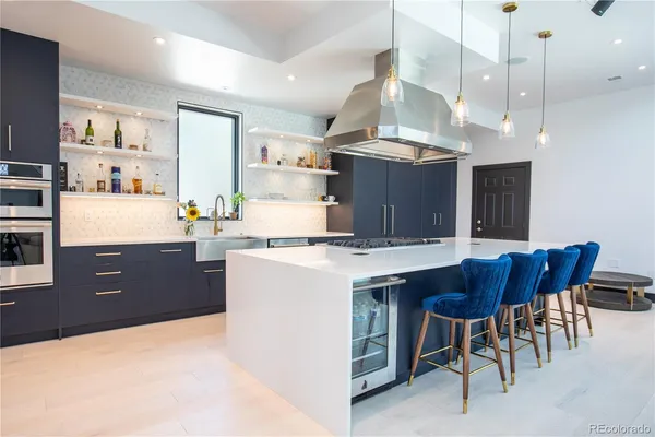 a kitchen with a table chairs stove and cabinets