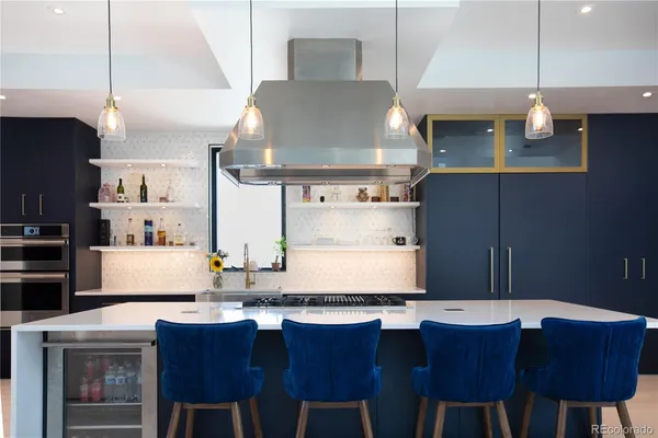 a large kitchen with stainless steel appliances kitchen island granite countertop a sink and cabinets