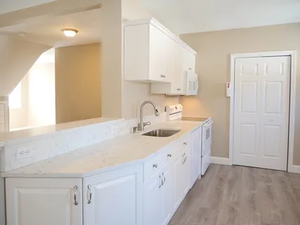 a kitchen with sink cabinets and window