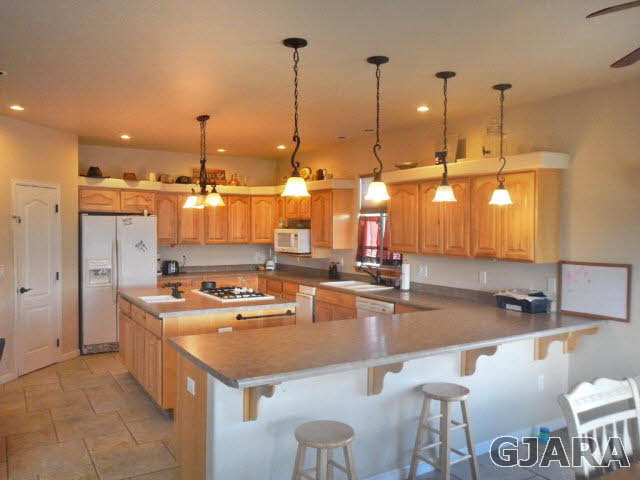 1454 19 Road Fruita, CO 81521 - Photo 2 of 9 a room with a table chairs and flat screen tv