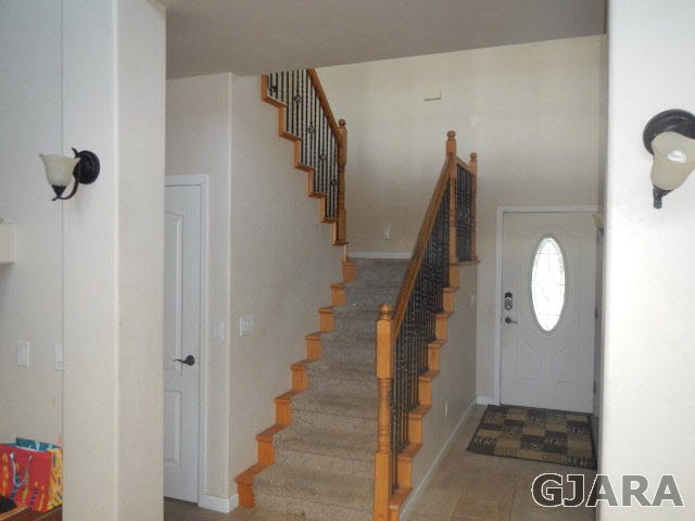 1454 19 Road Fruita, CO 81521 - Photo 7 of 9 a view of a hallway with wooden floor and staircase