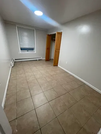 an empty room with a fireplace and windows