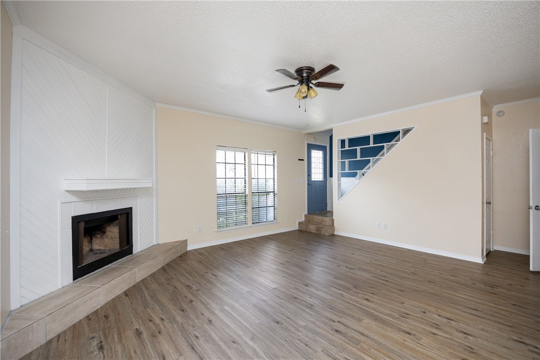 3052 Quail Springs Road, Unit A2 Corpus Christi, TX 78414 - Photo 12 of 31 a view of empty room with wooden floor and fireplace