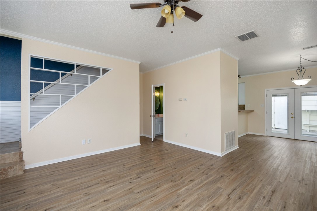 3052 Quail Springs Road, Unit A2 Corpus Christi, TX 78414 - Photo 14 of 31 wooden floor in an empty room with a window