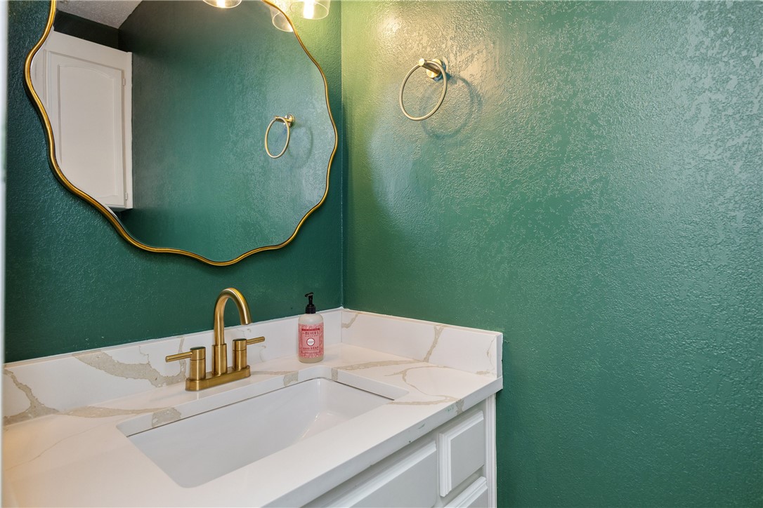 3052 Quail Springs Road, Unit A2 Corpus Christi, TX 78414 - Photo 15 of 31 a bathroom with a sink vanity and mirror