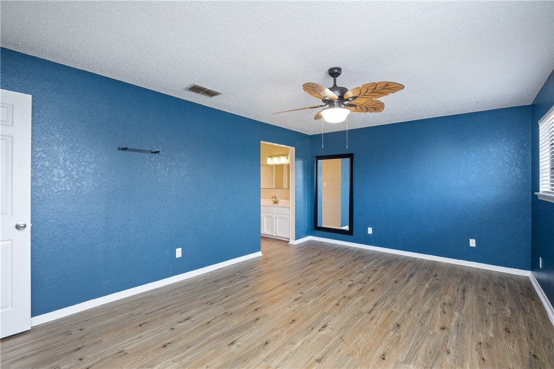 3052 Quail Springs Road, Unit A2 Corpus Christi, TX 78414 - Photo 18 of 31 a view of an empty room with window and wooden floor