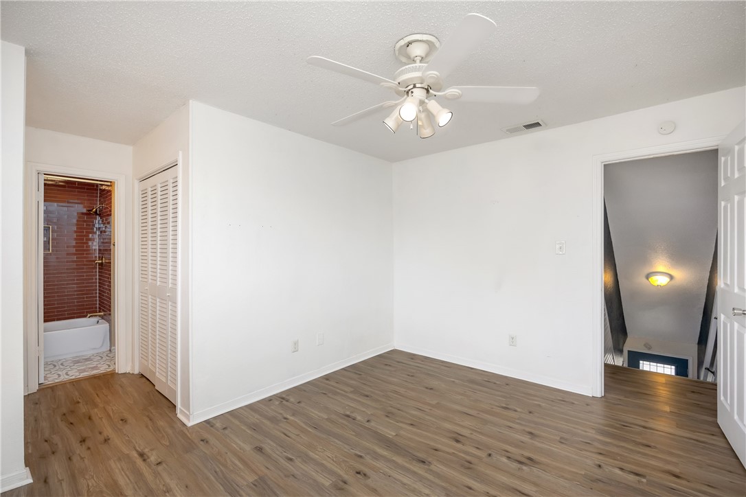 3052 Quail Springs Road, Unit A2 Corpus Christi, TX 78414 - Photo 22 of 31 a view of an empty room with wooden floor and closet