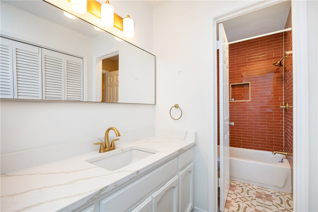 3052 Quail Springs Road, Unit A2 Corpus Christi, TX 78414 - Photo 23 of 31 a bathroom with a sink a mirror and a shower