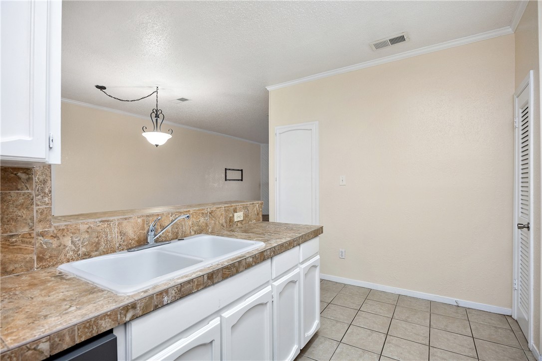 3052 Quail Springs Road, Unit A2 Corpus Christi, TX 78414 - Photo 7 of 31 a bathroom with a granite countertop sink and a mirror