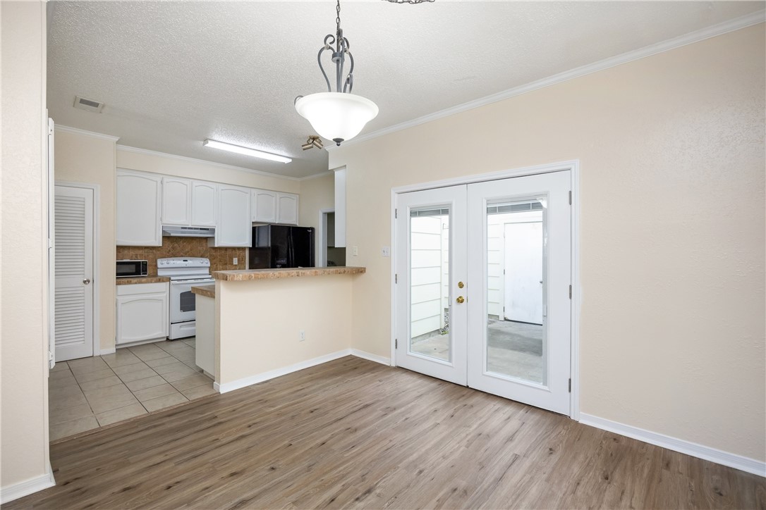 3052 Quail Springs Road, Unit A2 Corpus Christi, TX 78414 - Photo 10 of 31 a kitchen with white cabinets and stainless steel appliances