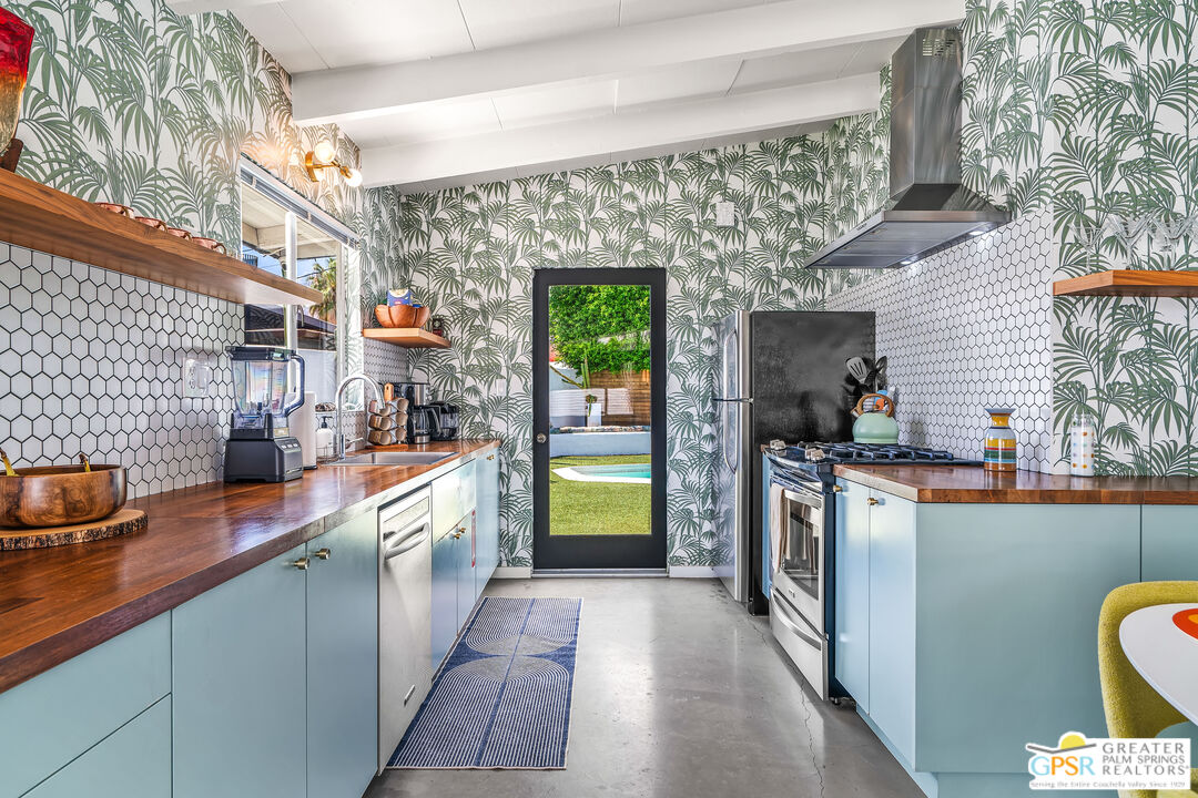 1655 Tamarisk Road Palm Springs, CA 92262 - Photo 11 of 39 a kitchen with stainless steel appliances a sink and a refrigerator
