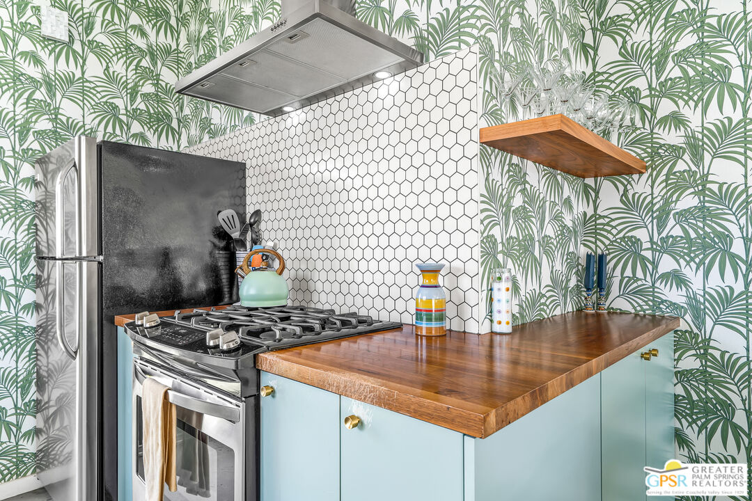 1655 Tamarisk Road Palm Springs, CA 92262 - Photo 12 of 39 a kitchen with a sink a stove and a wooden floor