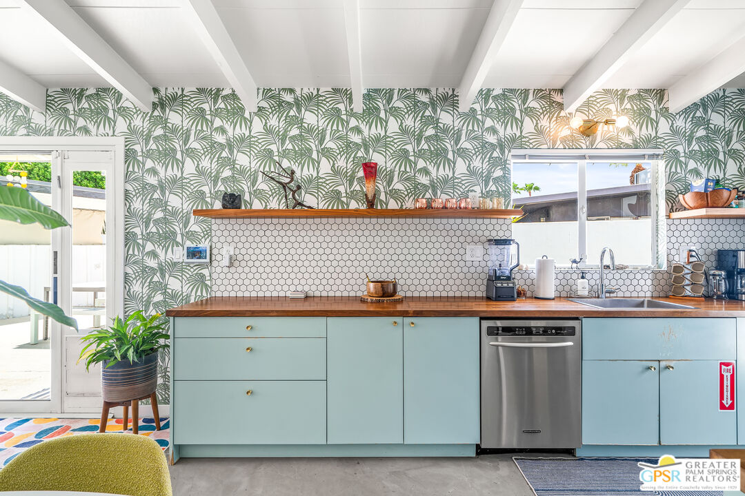 1655 Tamarisk Road Palm Springs, CA 92262 - Photo 14 of 39 a kitchen with stainless steel appliances granite countertop a sink and cabinets