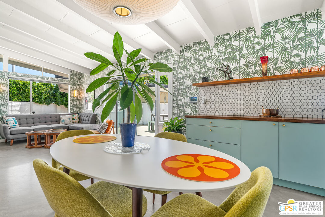 1655 Tamarisk Road Palm Springs, CA 92262 - Photo 18 of 39 a dining room with furniture and a potted plant
