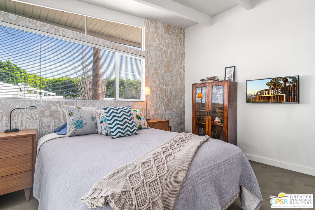 1655 Tamarisk Road Palm Springs, CA 92262 - Photo 22 of 39 a bedroom with a large bed and a large window