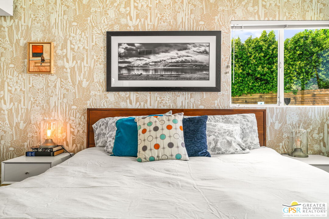 1655 Tamarisk Road Palm Springs, CA 92262 - Photo 26 of 39 a bedroom with a bed and a painting on the wall