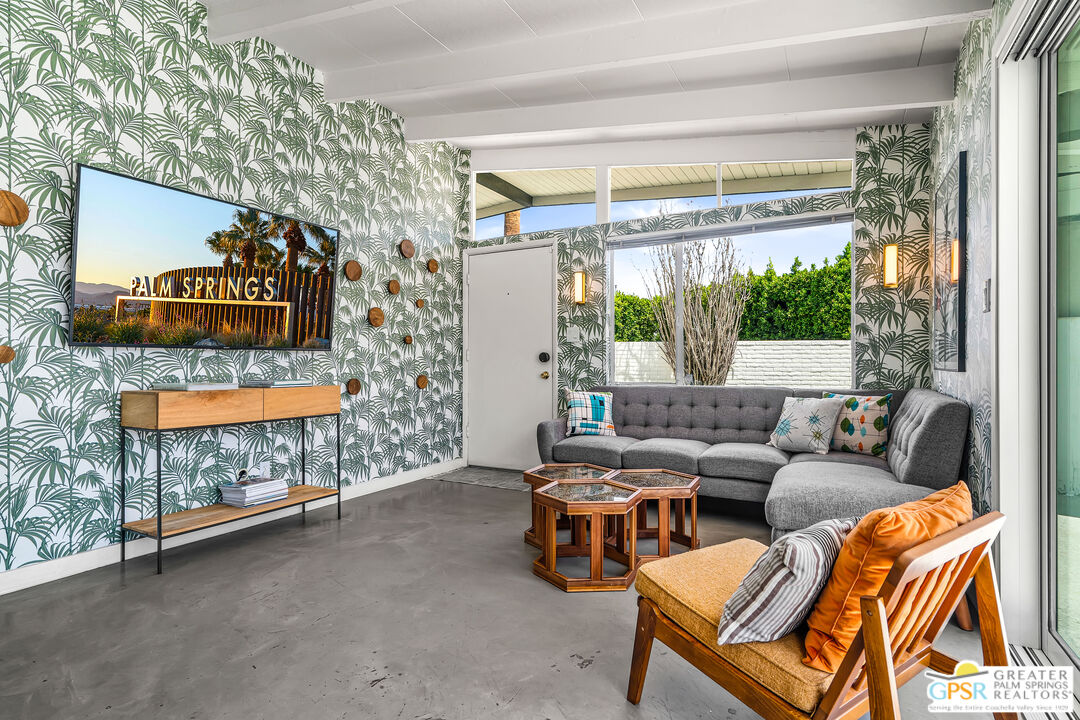 1655 Tamarisk Road Palm Springs, CA 92262 - Photo 10 of 39 a living room with furniture and a sign