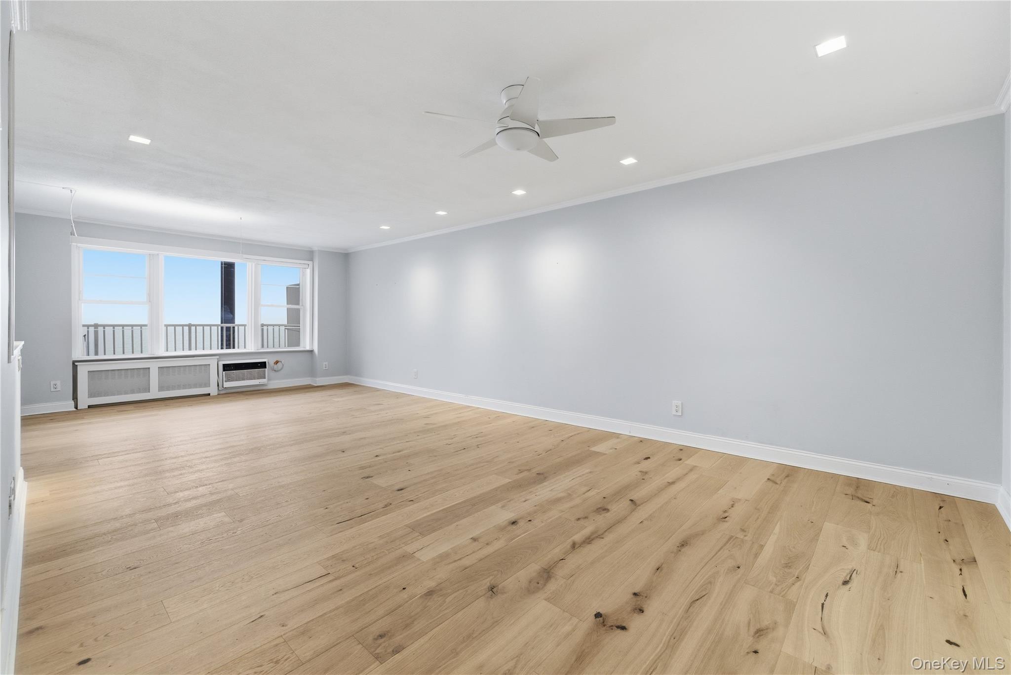 666 Shore Road, Unit 6M Long Beach, NY 11561 - Photo 12 of 24 a view of empty room with wooden floor and window