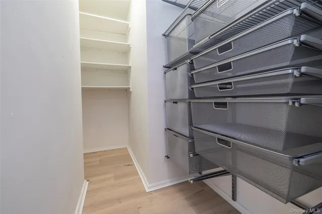 a view of walk in closet with empty racks