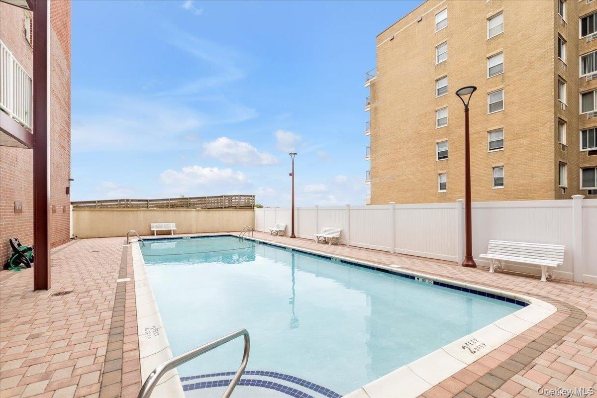 666 Shore Road, Unit 6M Long Beach, NY 11561 - Photo 19 of 24 a view of a swimming pool with seating area