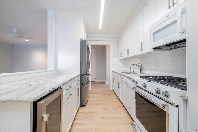 a large kitchen with granite countertop a sink and a stove