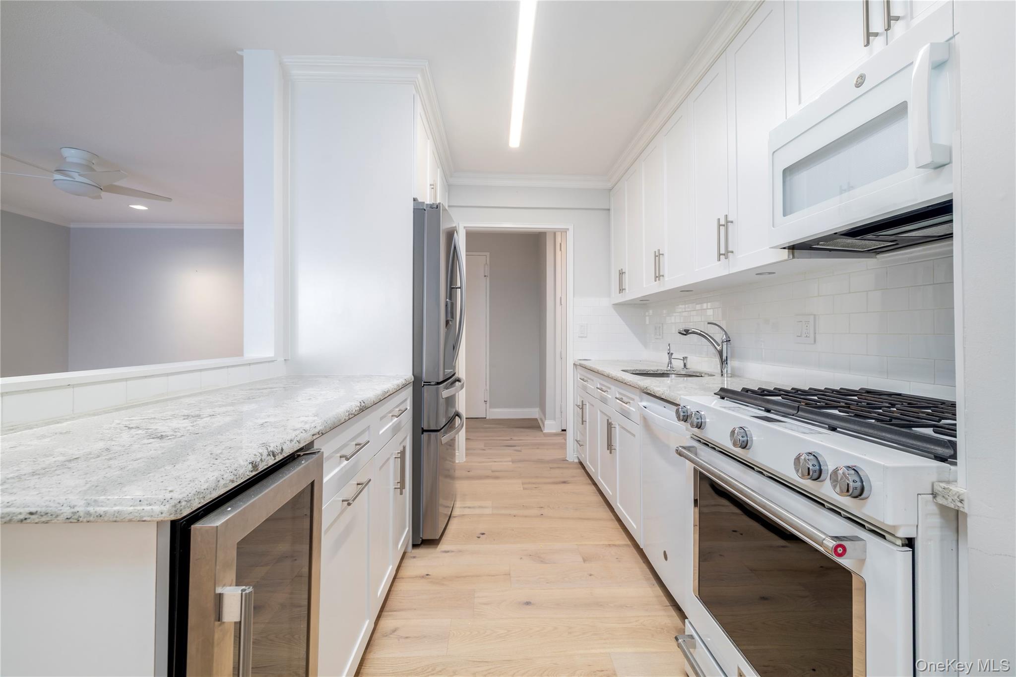 666 Shore Road, Unit 6M Long Beach, NY 11561 - Photo 5 of 24 a large kitchen with granite countertop a sink and a stove