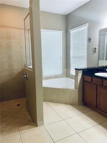 a bathroom with a granite countertop sink a toilet and bathtub
