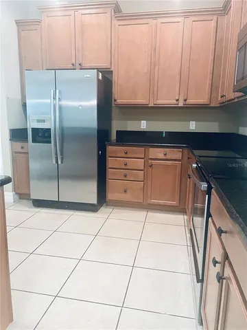 a kitchen with granite countertop a cabinets and appliances