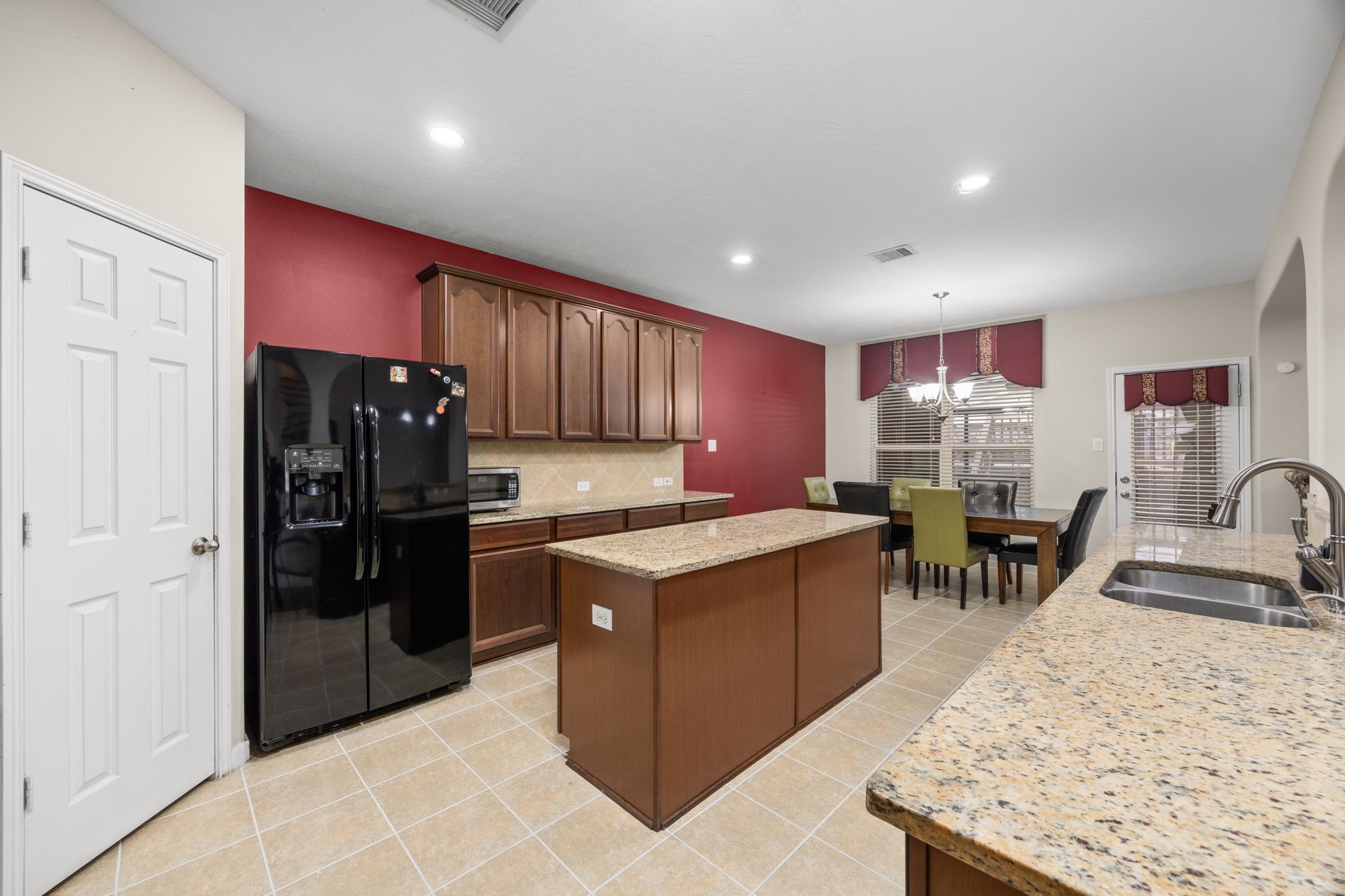 6719 Latchmore Lane Houston, TX 77049 - Photo 14 of 46 a kitchen with stainless steel appliances granite countertop a sink stove and refrigerator