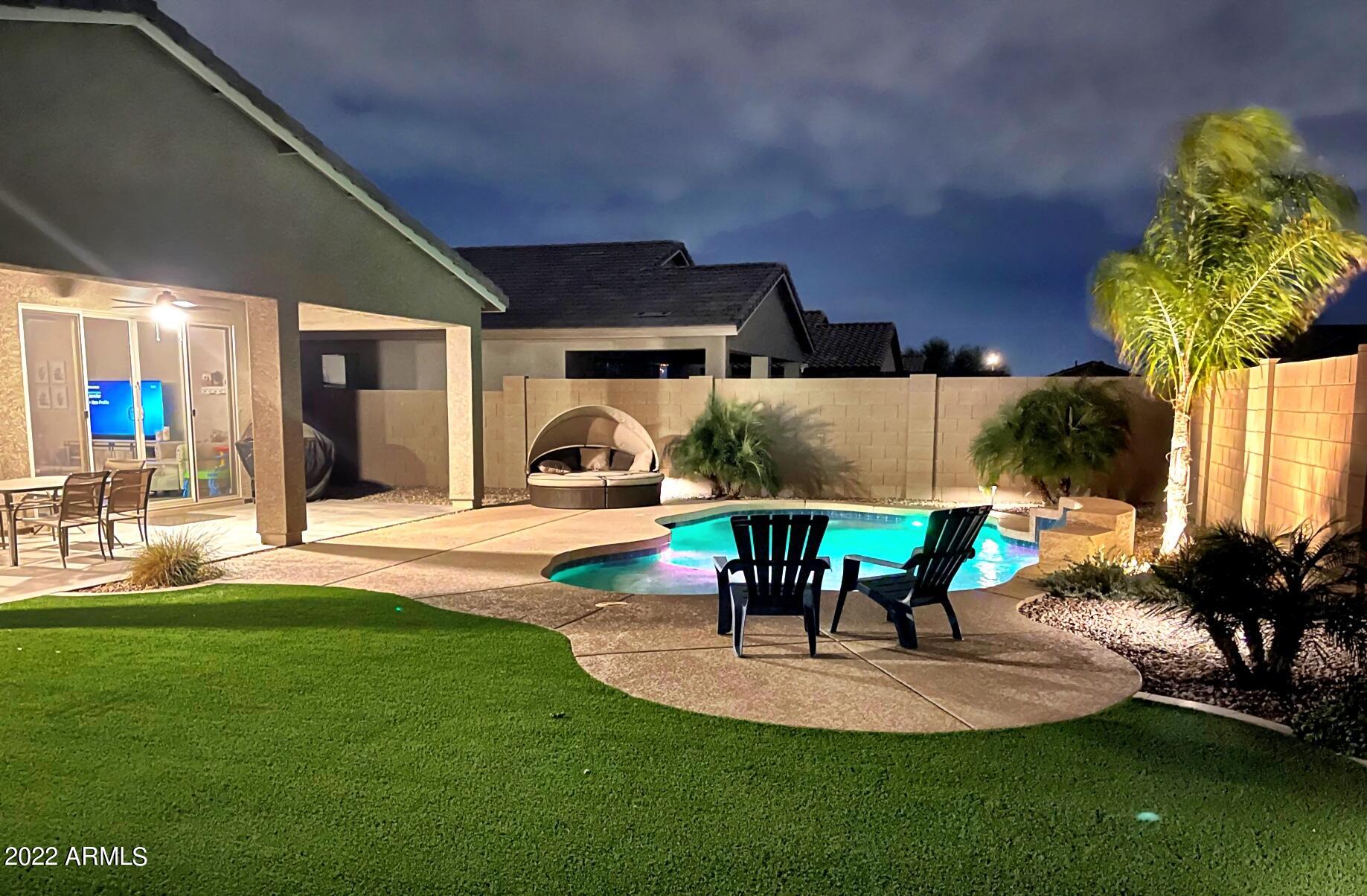 3330 West Fremont Rd. Phoenix, AZ 85041 - Photo 36 of 43 a view of a backyard with table and chairs potted plants and a fountain