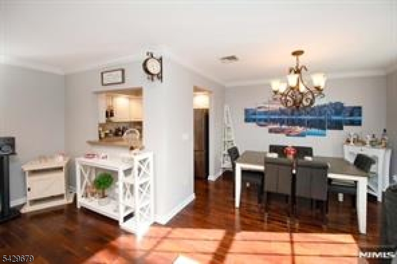 11A South Maple Avenue, Unit B Park Ridge, NJ 07656 - Photo 4 of 16 a view of a dining room with furniture a chandelier and wooden floor