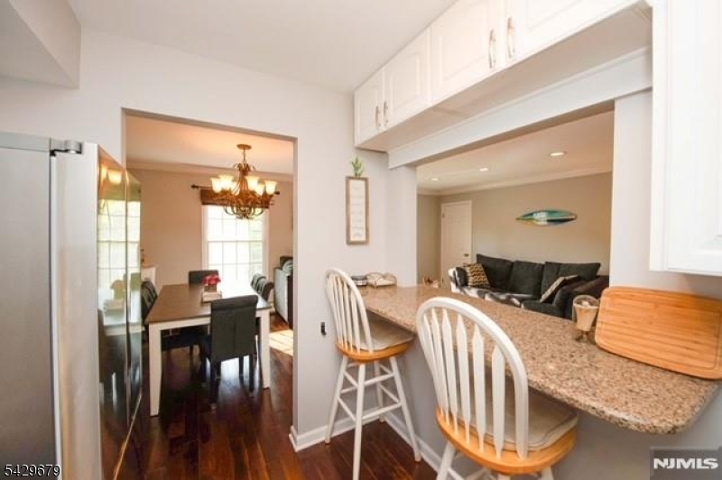 11A South Maple Avenue, Unit B Park Ridge, NJ 07656 - Photo 5 of 16 a bedroom with furniture and a wooden floor