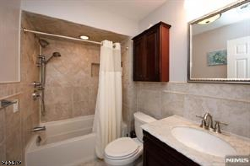 11A South Maple Avenue, Unit B Park Ridge, NJ 07656 - Photo 10 of 16 a bathroom with a sink toilet and shower