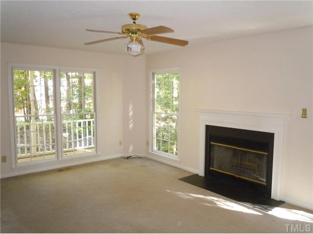 5304 Middleton Road Durham, NC 27713 - Photo 4 of 16 Living room has been freshly painted a more neutral color. Many windows and wood burning fireplace complete the room. Living Room
