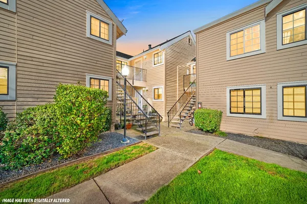 a view of a house with a yard and sitting area