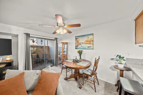 a view of a dining room with furniture and a chandelier