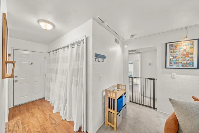 a view of a bedroom with furniture and a window