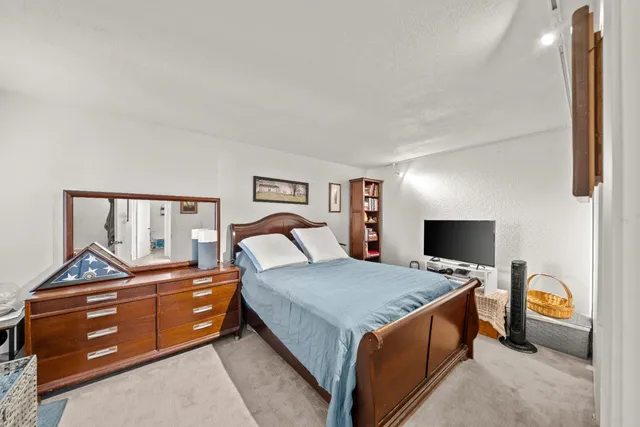 a bedroom with a bed and a dresser in it