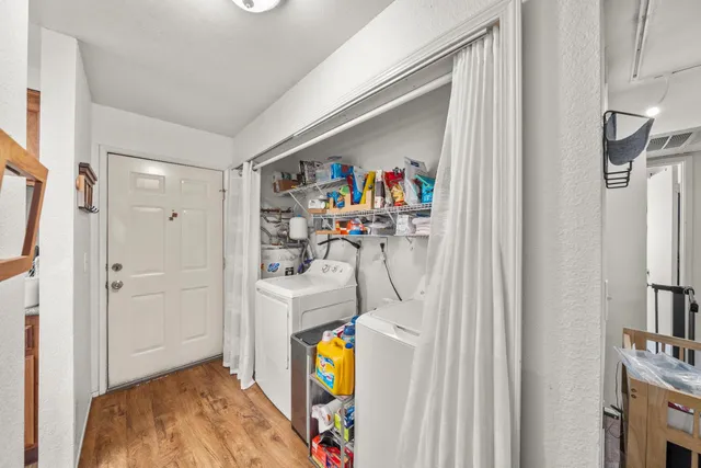 a view of walk in closet with clothes and shoes