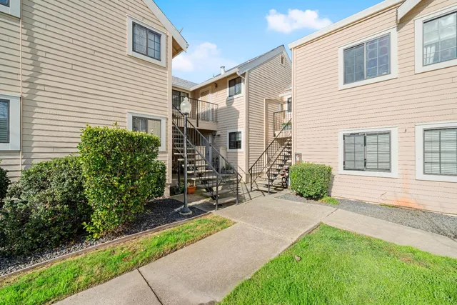 a view of a house with backyard and sitting area