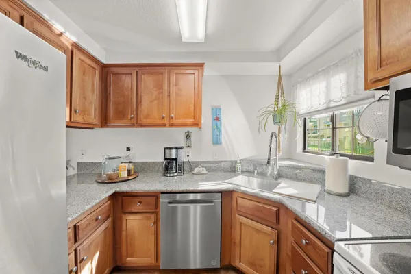 a kitchen with sink a window and cabinets
