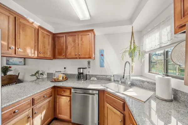 a kitchen with sink cabinets and window