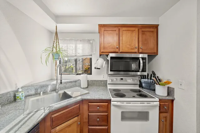 a kitchen with a stove a sink and a microwave