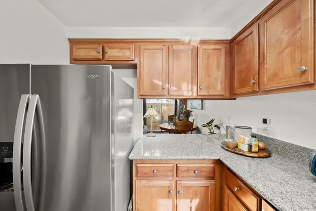 a kitchen with a sink a refrigerator and cabinets