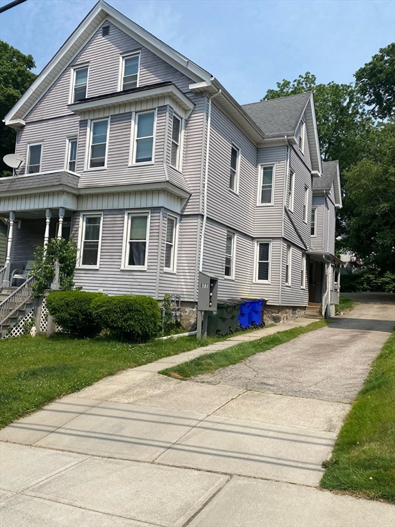 877 High Street Fall River, MA 02720 - Photo 1 of 26 a front view of a house with a yard