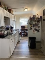 877 High Street Fall River, MA 02720 - Photo 15 of 26 a kitchen with stainless steel appliances kitchen island granite countertop a refrigerator and a stove