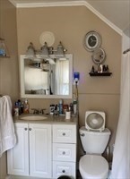 877 High Street Fall River, MA 02720 - Photo 16 of 26 a bathroom with a toilet a sink and mirror