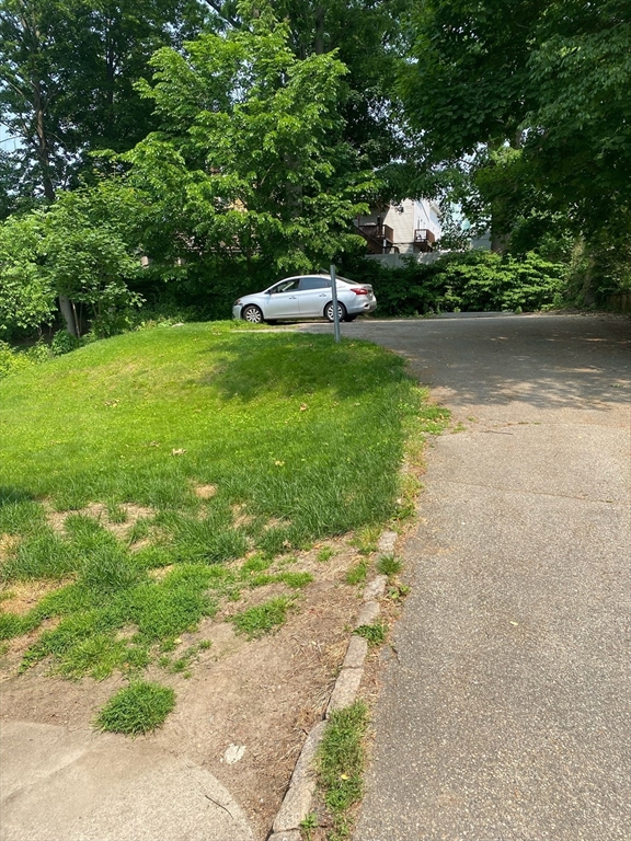 877 High Street Fall River, MA 02720 - Photo 2 of 26 a view of a garden with a bench