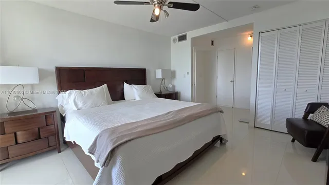 a bedroom with bed and a chandelier