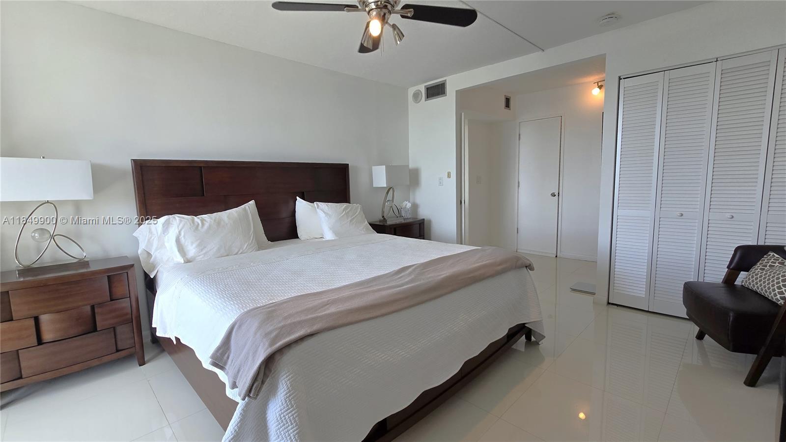 3731 North Country Club Drive, Unit 1825 Aventura, FL 33180 - Photo 15 of 25 a bedroom with bed and a chandelier